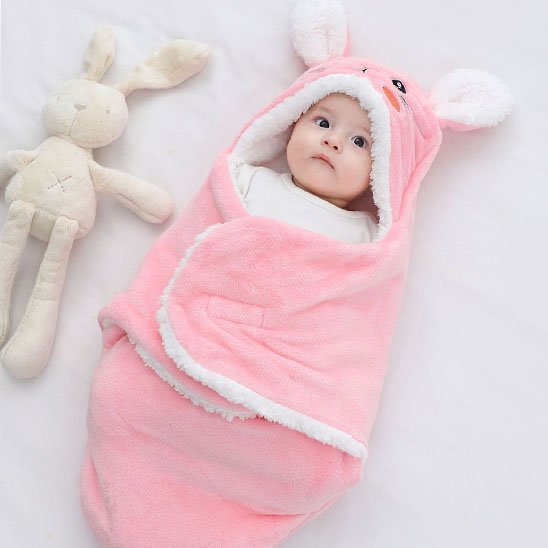 Bébé emmailloté dans un nid d'ange rose avec capuche à oreilles de lapin, couverture douce et chaude pour nouveau-né.