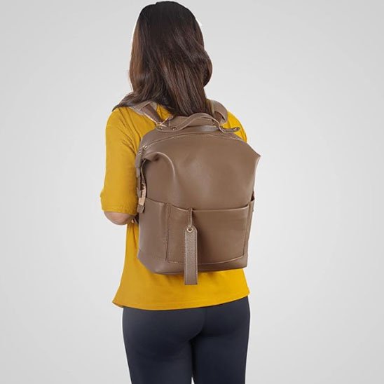 Femme portant un sac à langer marron au dos